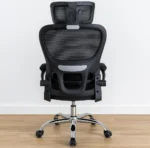 Ergonomic black mesh high-back office chair with an adjustable headrest, flip-up padded armrests, and a polished chrome swivel base.