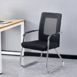 Black mesh medium-back conference chair with integrated armrests and a chrome sled base frame.