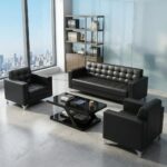 5-seater office sofa set in smooth black faux leather, featuring a three-seater couch and two matching single-seater armchair sofas, all styled with distinctive square grid tufting across the backrests and seats, straight block armrests, and sleek silver metal corner feet.