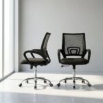 Black clerical office chair shown in a pair from front and angled perspectives, featuring a breathable black mesh mid-back backrest with integrated lumbar support, a contoured fabric-padded seat cushion, fixed curved nylon armrests, a pneumatic height-adjustment mechanism, and a polished chrome five-star swivel base on dual-wheel casters.