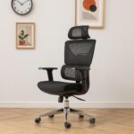 Padded black fabric seat cushion on an ergonomic orthopedic chair with a waterfall edge design for thigh pressure relief.