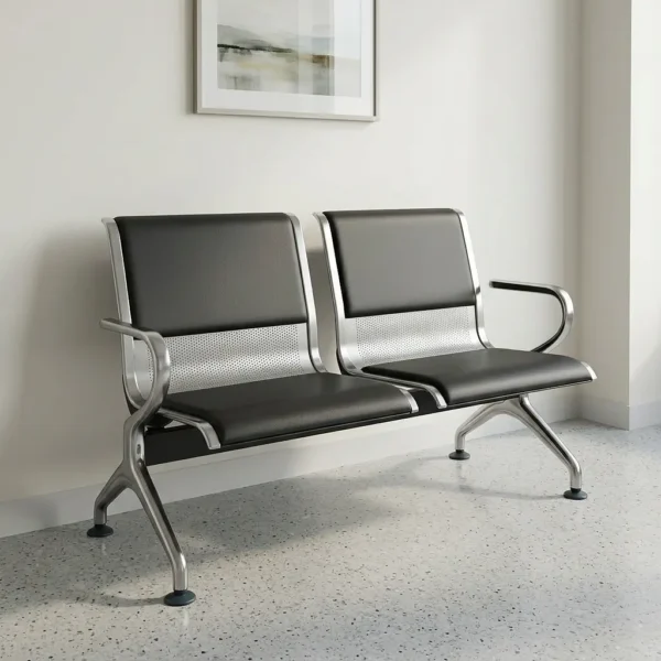 2 seater waiting bench constructed with a durable stainless steel frame and curved metal armrests, featuring two connected seats upholstered with padded black faux leather backrests and seat cushions, accented by integrated perforated steel middle panels, all supported by flared, arched silver legs with adjustable non-slip floor glides.