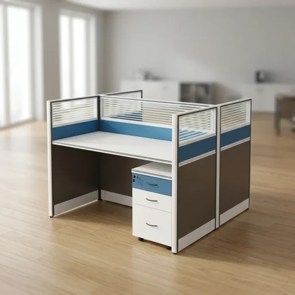 2 way office working station featuring a back-to-back dual desk modular cubicle layout with smooth white desktops, enclosed by privacy panel dividers with dark gray lower sections, solid blue middle accent bands, and upper horizontal-striped frosted glass inserts in white frames, complete with an under-desk mobile three-drawer pedestal file cabinet on rolling casters with a blue key-locked top drawer.