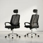 Black mesh adjustable staff chair with a padded headrest, ergonomic lumbar frame, curved armrests, and a chrome 5-star swivel base.