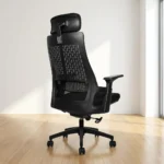 Mesh high back ergonomic chair featuring a breathable black mesh backrest with a distinct patterned matrix outer shell, an integrated adjustable lumbar support band, a wide contoured fabric-padded seat cushion, an adjustable curved mesh headrest, T-shaped armrests, an under-seat pneumatic adjustment lever, and a heavy-duty matte black five-star swivel base on dual-wheel casters.