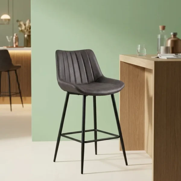 Dark gray faux leather barstool with a ribbed vertical-tufted backrest and tapered black metal legs with a built-in footrest.