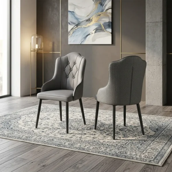 Gray faux leather dining chairs featuring a diamond button-tufted backrest, textured fabric outer back, and tapered dark metal legs.