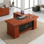 1.6m executive office desk in a rich reddish-brown cherry wood veneer finish, featuring a traditional rectangular tabletop with an integrated black leather desk blotter inlay, an attached side return credenza, and a black front modesty panel detailed with a central diamond-shaped wood accent.
