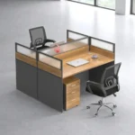 2 way office workstation arranged in a face-to-face configuration, featuring natural wood grain tabletops enclosed by charcoal gray privacy partition panels topped with frosted glass dividers, paired with a matching under-desk three-drawer mobile filing cabinet with lock.