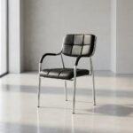 Stackable catalina waiting chair featuring a low-profile square backrest and matching seat cushion upholstered in grid-tufted black faux leather, integrated curved black padded armcaps, and a four-legged stackable polished chrome tubular steel frame.