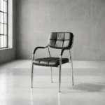 Stackable catalina waiting chair featuring a low-profile square backrest and matching seat cushion upholstered in grid-tufted black faux leather, integrated curved black padded armcaps, and a four-legged stackable polished chrome tubular steel frame.
