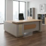 1.8m L-shaped executive desk featuring a natural light oak wood grain tabletop with rounded corners, integrated into a premium matte beige or champagne chassis, designed with a large built-in side return credenza, vertical gold metallic inlay accents on the front pedestal, and a matching oak wood center panel design on the front modesty board.