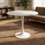 Round marble dining table featuring a thin, circular white marble tabletop with subtle gray veining, supported by a classic mid-century modern white tulip pedestal base with a slender tapered stem and a solid circular floor plate.