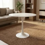 Round marble dining table featuring a thin, circular white marble tabletop with subtle gray veining, supported by a classic mid-century modern white tulip pedestal base with a slender tapered stem and a solid circular floor plate.
