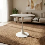 Round marble dining table featuring a thin, circular white marble tabletop with subtle gray veining, supported by a classic mid-century modern white tulip pedestal base with a slender tapered stem and a solid circular floor plate.