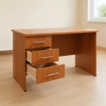 1.0m office study desk finished in a warm cherry wood grain laminate, featuring a rectangular writing surface, an integrated three-drawer side pedestal on the right with a top-drawer key lock, modern silver horizontal bar handles, a solid left panel leg support, and a matching wood modesty panel.