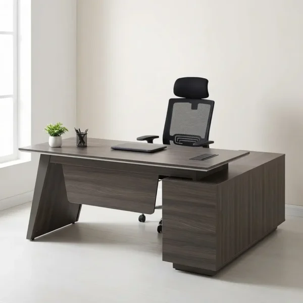 160cm L-shaped executive desk crafted in a dark gray wood grain finish, featuring a floating rectangular main tabletop with an integrated rectangular flip-up cable management grommet, a matching angled left panel leg, a contoured floating front modesty panel, and an attached right-side return credenza cabinet with a solid block plinth base.