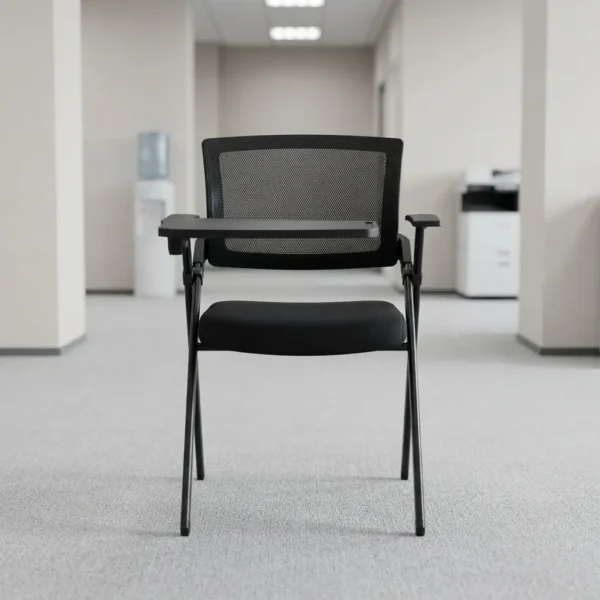Foldable chair with writing pad featuring a breathable black mesh backrest, a thick padded black fabric seat cushion, a black metal folding scissor frame, and an integrated right-handed flip-up plastic tablet arm desk equipped with a built-in cup holder, anchored by short fixed armrests.