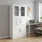 Office cabinet with safe featuring a heavy-duty white steel modular construction, designed with a top double-door storage compartment with rectangular glass viewing panels, a middle section containing three stacked utility drawers next to a single key-locked locker door, and a lower double-door storage cabinet, all equipped with integrated flush-mount handles and independent security key locks.