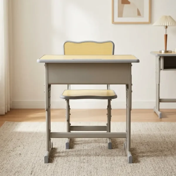 Kids study desk and chair set featuring a height-adjustable design, with both pieces supported by a durable matte gray steel frame. The desk is constructed with a rectangular light yellow top with a light blue safety border, an integrated open-front book storage shelf underneath, and T-leg bases, paired with a matching ergonomic chair featuring a yellow seat and backrest trimmed in light blue.