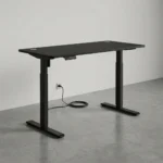 1.2m electric adjustable table featuring a matte black desktop with dual grommet holes, an under-desk digital controller, and heavy-duty black T-style lifting columns.