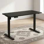 1.2m electric adjustable table featuring a matte black desktop with dual grommet holes, an under-desk digital controller, and heavy-duty black T-style lifting columns.