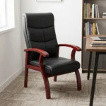 High back leather waiting chair featuring segmented black leather upholstery with horizontal stitching, curved cherry wood armrests, and matching flared wooden legs.