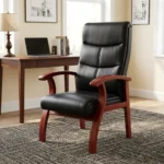 High back leather waiting chair featuring segmented black leather upholstery with horizontal stitching, curved cherry wood armrests, and matching flared wooden legs.