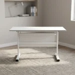 120cm foldable training table featuring a clean white rectangular desktop, an integrated under-desk metal storage shelf, a matching white modesty panel, and a T-bar steel leg base.