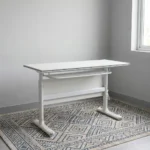 120cm foldable training table featuring a clean white rectangular desktop, an integrated under-desk metal storage shelf, a matching white modesty panel, and a T-bar steel leg base.