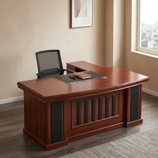 1.8m executive office desk featuring a rich, reddish-brown wood-grain finish, an integrated black writing pad inlay with dual grommet holes, a matching L-shaped side return cabinet, and a classic front modesty panel accented with vertical black inserts.