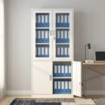 Lockable steel office file cabinet featuring a clean white finish, an upper lockable double-door cupboard with glass display windows revealing interior shelving, and a lower matching solid steel double-door storage cabinet with vertical metal handles.