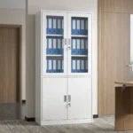 Lockable steel office file cabinet featuring a clean white finish, an upper lockable double-door cupboard with glass display windows revealing interior shelving, and a lower matching solid steel double-door storage cabinet with vertical metal handles.
