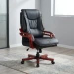 Directors executive office chair featuring a high-back black leather design with plush contoured cushioning and contrast stitching, curved reddish-brown wooden armrests, and a matching wooden five-star swivel base.