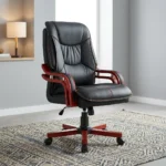 Directors executive office chair featuring a high-back black leather design with plush contoured cushioning and contrast stitching, curved reddish-brown wooden armrests, and a matching wooden five-star swivel base.