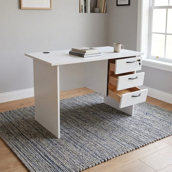 0.9m office study desk featuring a clean white finish, a circular black cable grommet on the tabletop, a matching modesty panel, and an integrated three-drawer pedestal with black curved handles and a lockable top drawer.