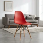 Red Eames plastic chair featuring a molded red plastic shell seat, tapered natural wooden legs, and black metal wire Eiffel-style cross-bracing.