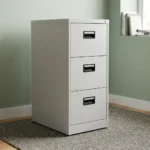 3-drawer lockable filing cabinet featuring a clean light gray steel finish and three vertical storage drawers, each equipped with an integrated black recessed pull handle and a built-in label slot.