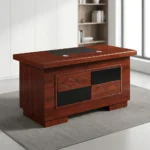1.4m executive office desk featuring a rich, reddish-brown wood-grain finish, an integrated black writing pad inlay with dual silver grommets, and a decorative front modesty panel detailed with a checkerboard pattern of solid black panels and overlapping diamond wood-carved designs.