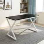 1.2m generic computer table featuring a sleek, rectangular black tabletop with a circular black cable grommet, supported by a modern geometric white metal X-frame leg base.