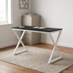 1.2m generic computer table featuring a sleek, rectangular black tabletop with a circular black cable grommet, supported by a modern geometric white metal X-frame leg base.
