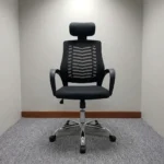 Black headrest office chair featuring a black mesh backrest with a visible ribbed spine support pattern, an adjustable padded black headrest, curved black loop armrests, a contoured padded black seat, and a polished chrome five-star swivel base.