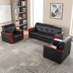 5-seater executive office sofa set featuring premium black leather upholstery with block-tufted backrests and padded headrests, accented by polished reddish-brown wooden panels capping the armrests, including a three-seater sofa and two matching single-seater armchairs.