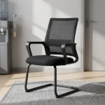 Premium office visitor chair featuring a mid-back black mesh backrest with an integrated horizontal lumbar support pad, curved black loop armrests, a contoured padded black seat, and a durable matte black cantilever sled base.