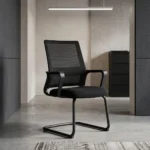 Premium office visitor chair featuring a mid-back black mesh backrest with an integrated horizontal lumbar support pad, curved black loop armrests, a contoured padded black seat, and a durable matte black cantilever sled base.