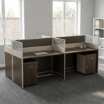 4-way modular workstation featuring a rich dark wood-grain finish, central and side privacy divider panels with white-slatted top accents, circular white cable grommets, and two matching under-desk mobile pedestals, each equipped with a top drawer and a lower cabinet door with silver handles.