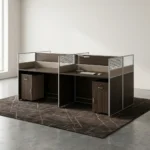 4-way modular workstation featuring a rich dark wood-grain finish, central and side privacy divider panels with white-slatted top accents, circular white cable grommets, and two matching under-desk mobile pedestals, each equipped with a top drawer and a lower cabinet door with silver handles.