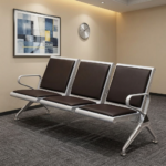 Heavy duty reception waiting bench featuring a robust three-seater silver metallic frame, padded black leather seat and backrest cushions for each section, integrated curved silver armrests at both ends, and angled support legs with adjustable leveling feet.