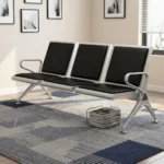 3-link black waiting bench featuring a robust three-seater silver metallic frame, padded black leather seat and backrest cushions for each section, integrated curved silver armrests at both ends, and angled support legs with adjustable leveling feet.