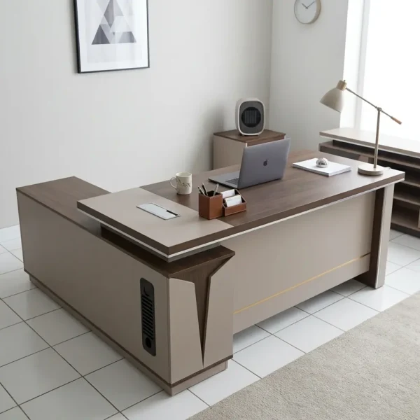 1.6m L-shaped executive desk featuring a modern two-tone design with a rich dark wood-grain tabletop and matte light-beige panels, an integrated side return cabinet with a vertical black ventilation detail, an embedded writing pad, a rectangular silver cable management cover, and a full modesty panel highlighted by a thin gold accent line.